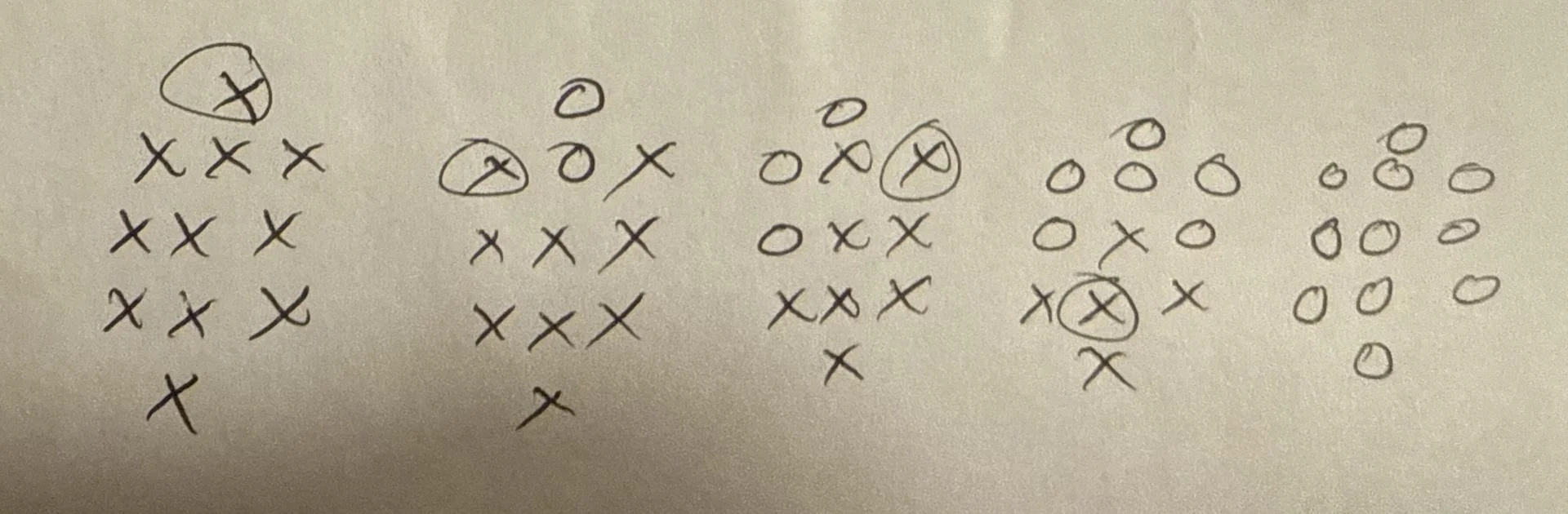 Grids of X's and O's on paper